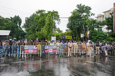 Kolkata Doctor Rape-Murder: Security personnel stand guard during a protest march of supporters of football clubs East Bengal and Mohun Bagan
